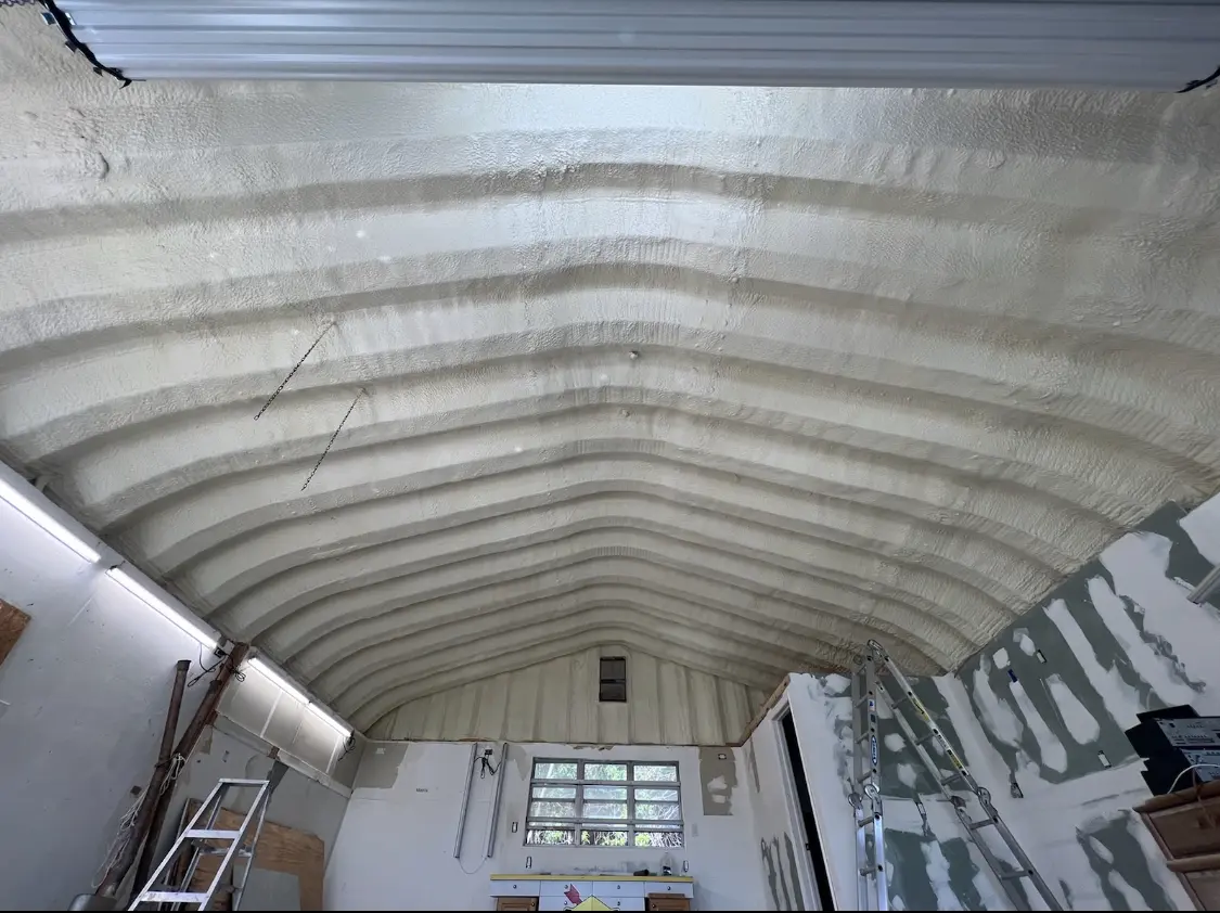 Spray polyurethane foam applied to the underside of a metal roof deck in Hays
